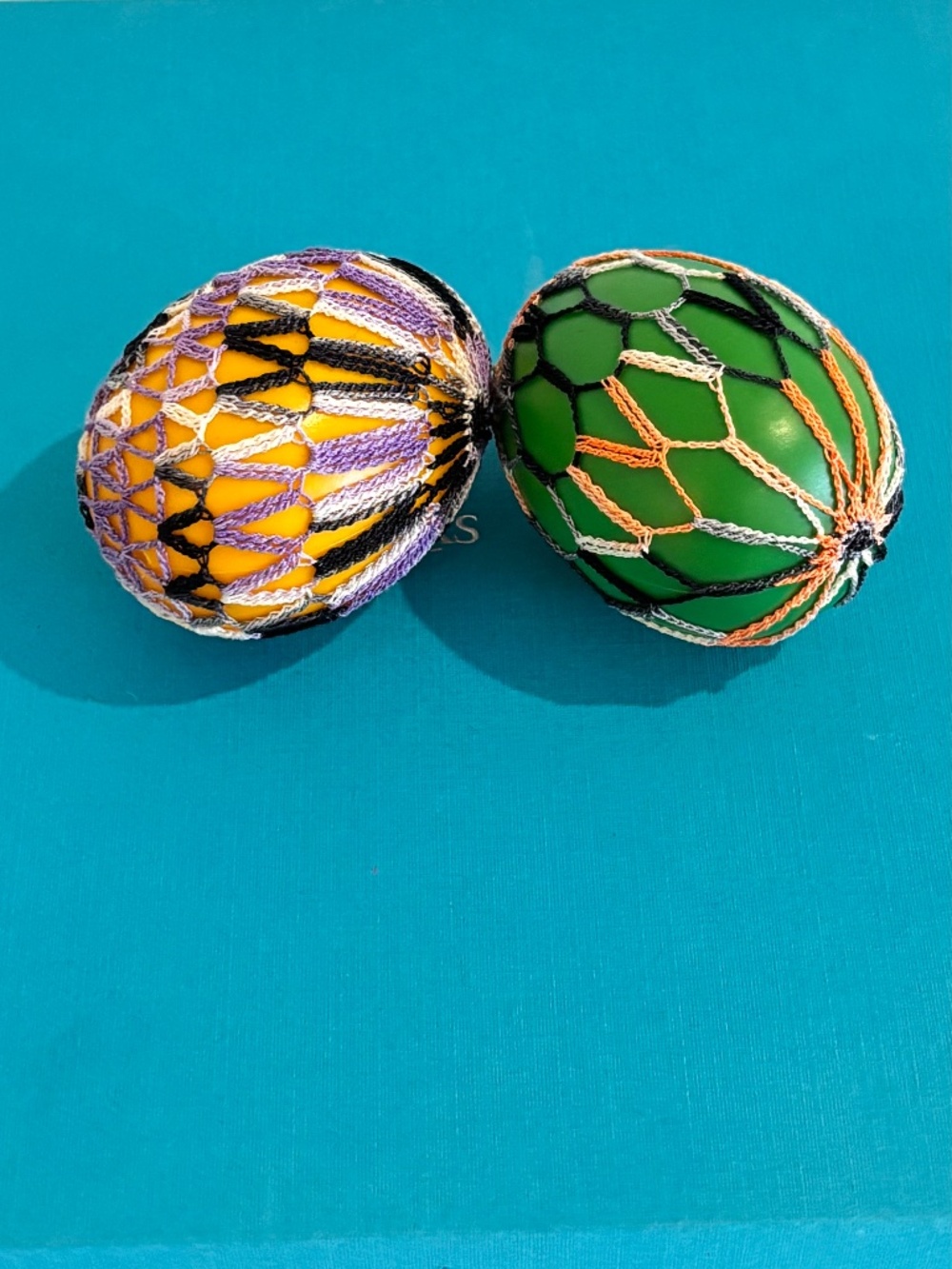 Vintage lace adorned Easter eggs delicate thread work patterns over plastic eggs